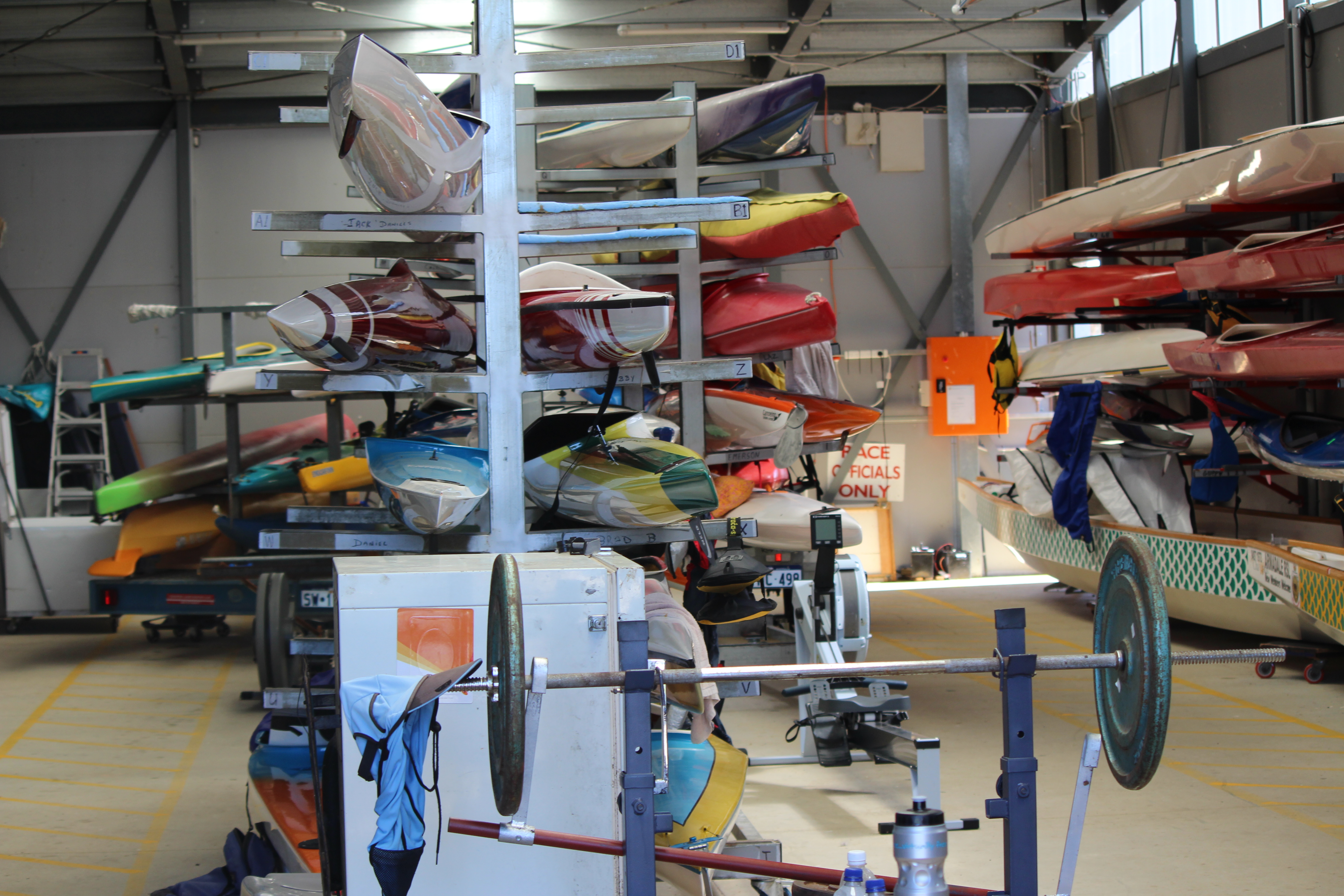 A photo showing boats being held in storage racks inside a storage shed at the Champion Lakes Regatta Centre