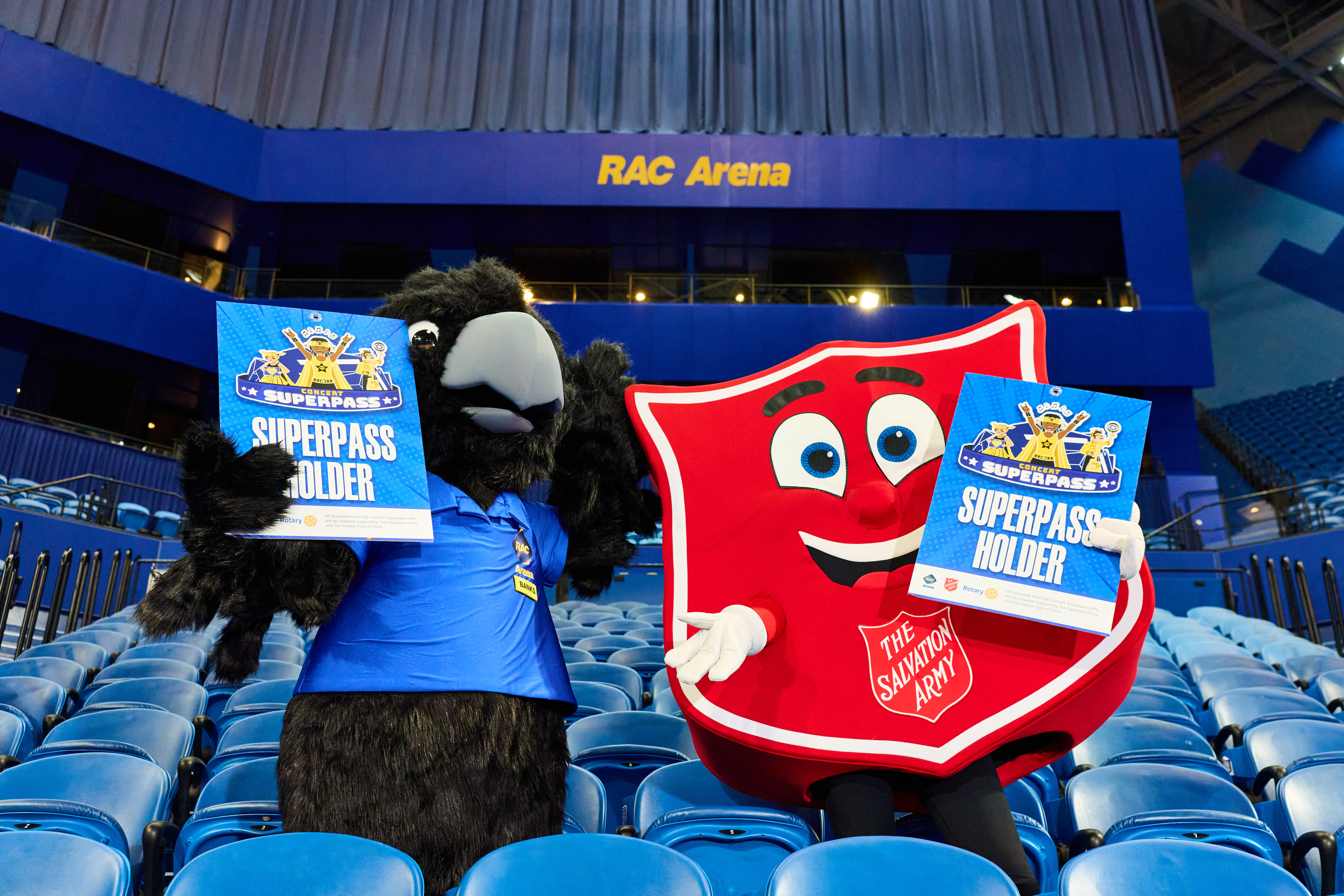 Red-tailed black cocktail mascot Banks and the red shield Salvation Army mascot each hold a superpass