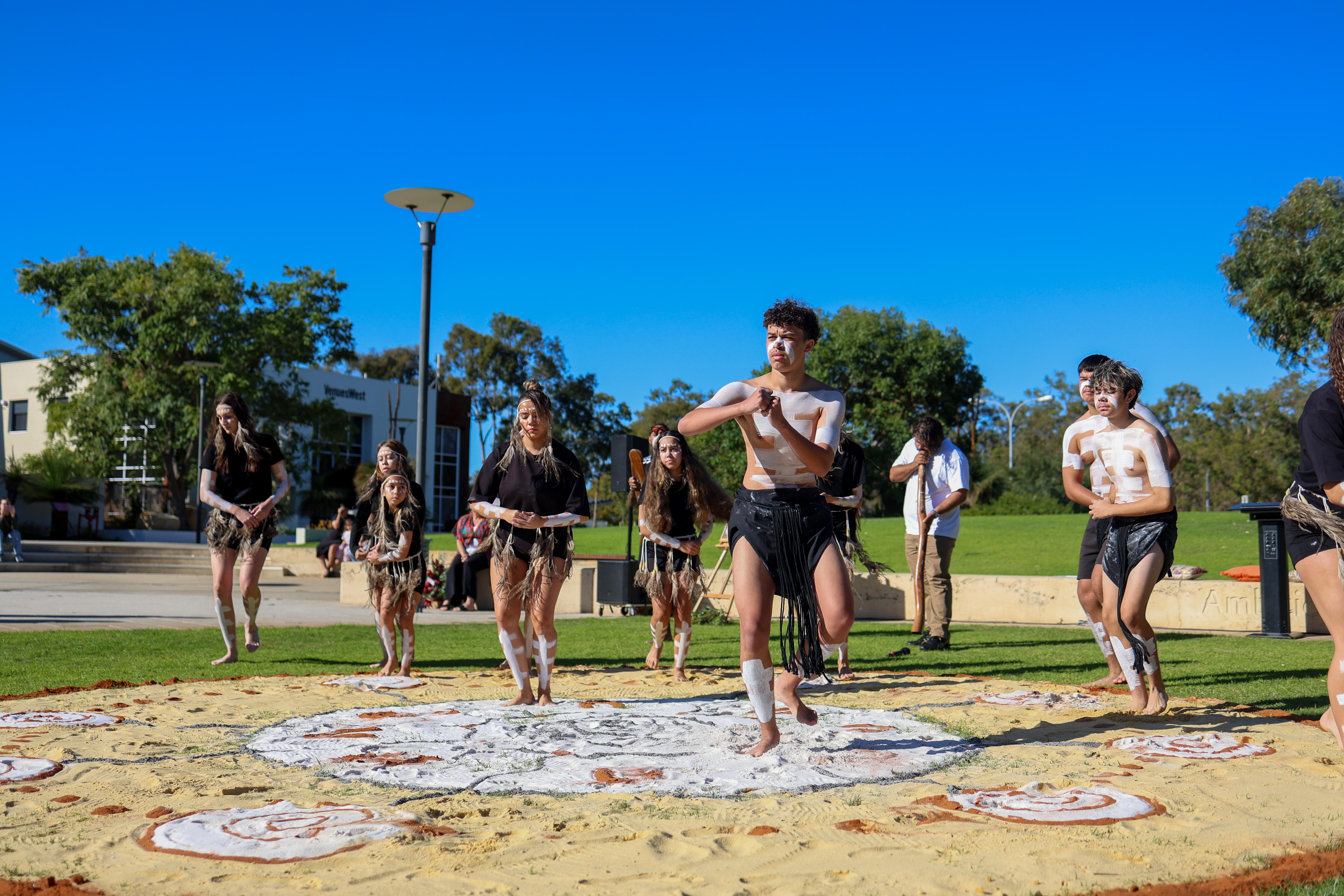 A photo of indigenous peoples conducting a ceremony outside of the VenuesWest building